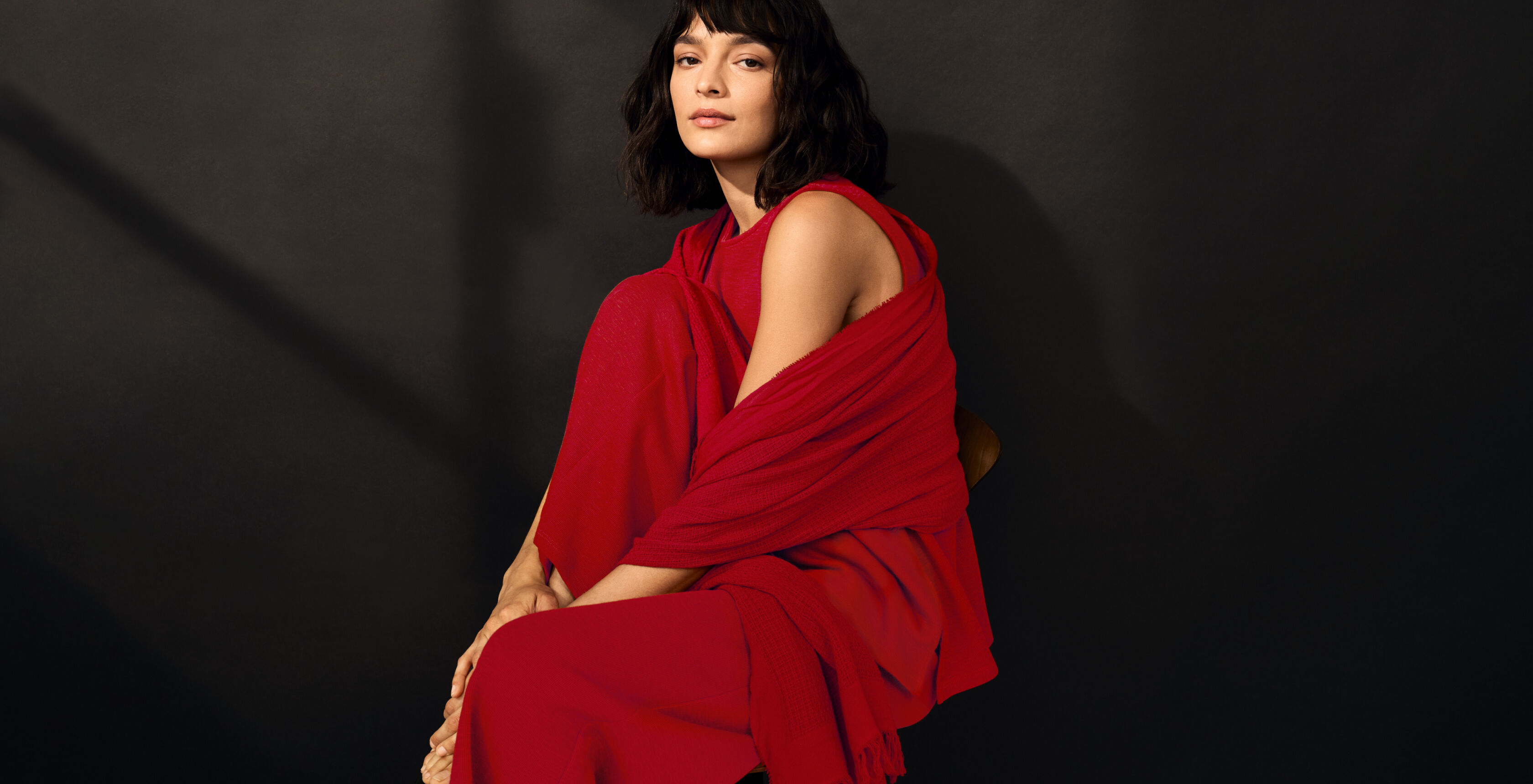 EILEEN FISHER model wearing a matching red outfit.