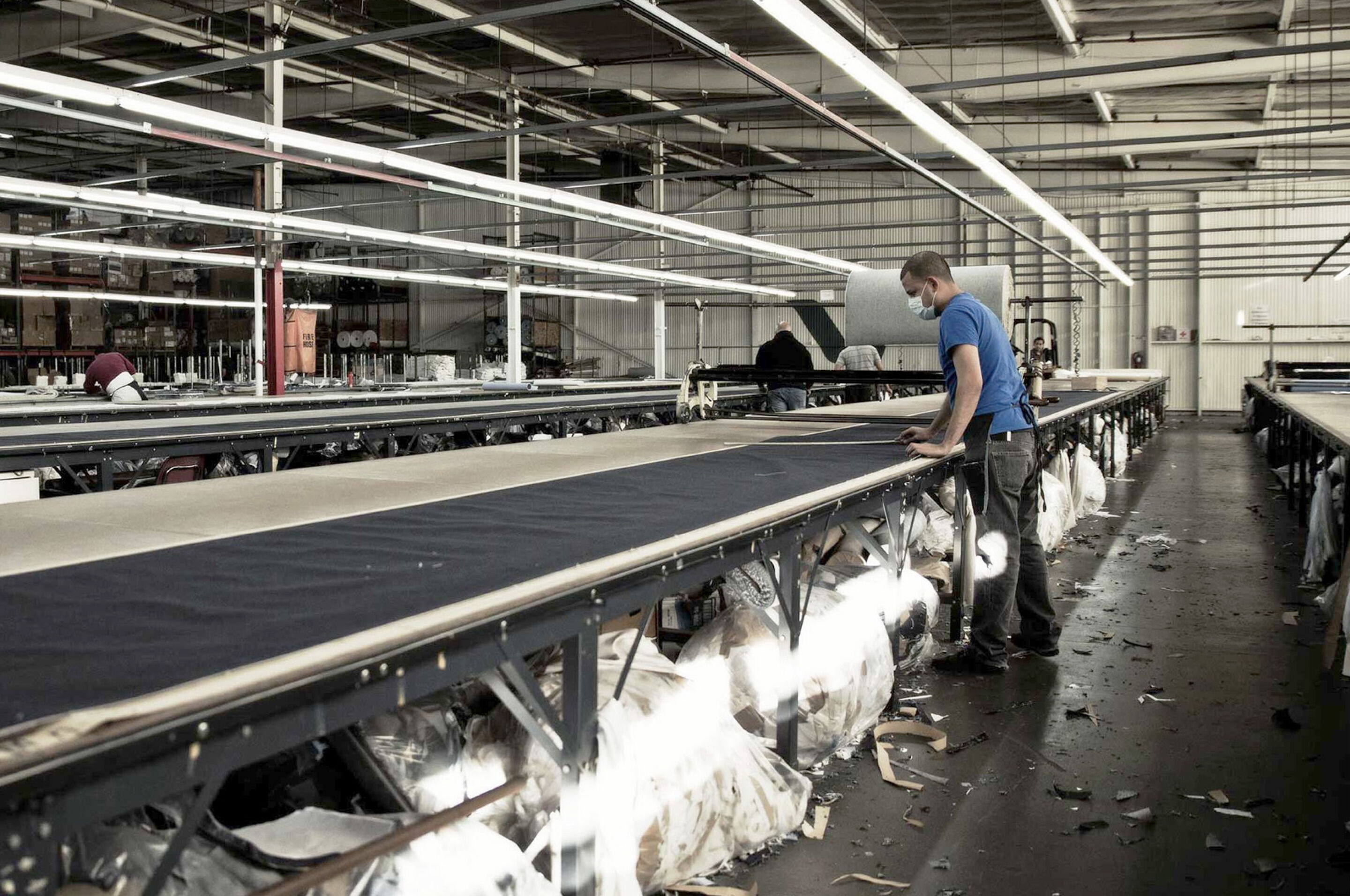 Man working at a textile factory. Man working at a textile factory.