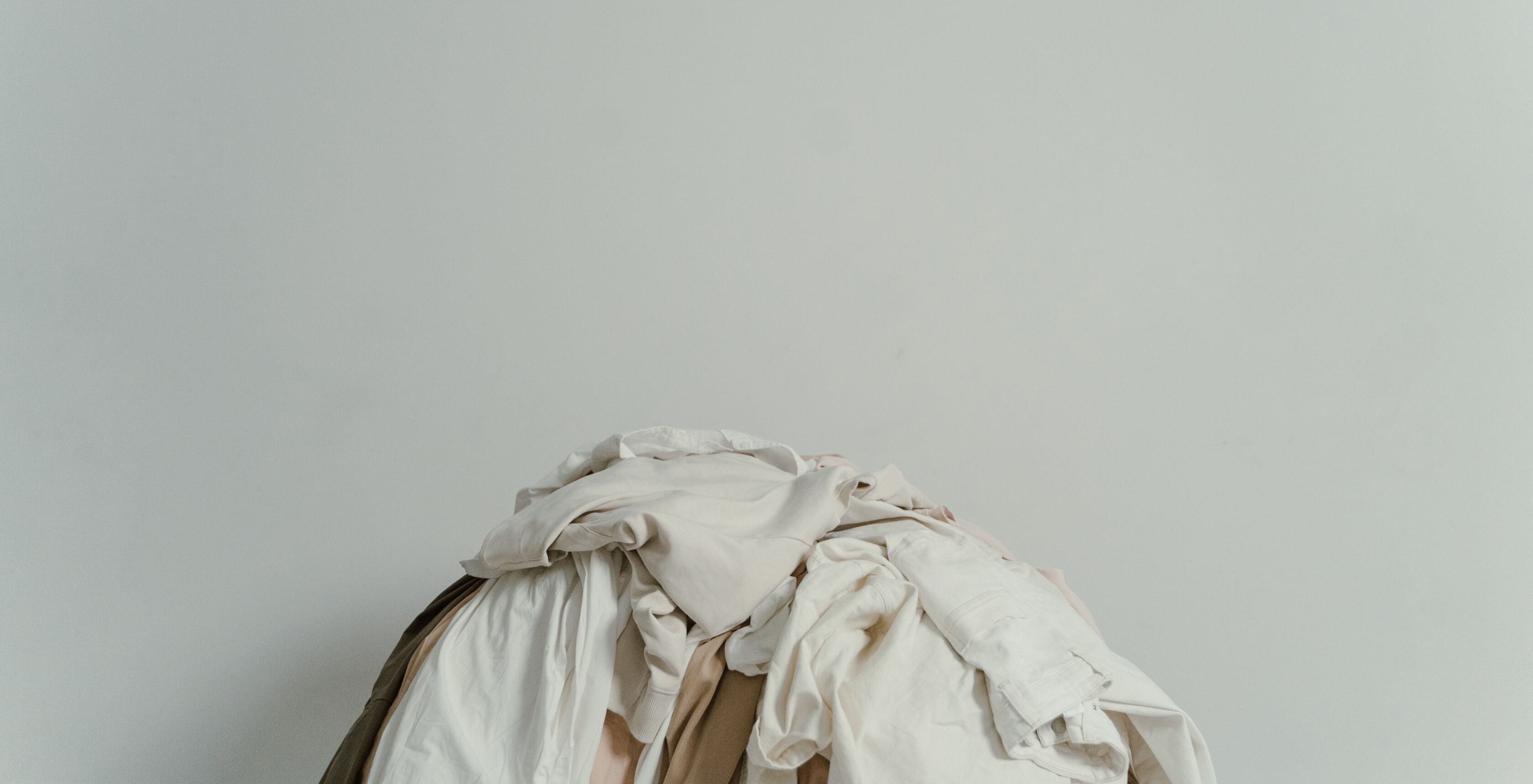 A pile of neutral clothing. A pile of neutral clothing.