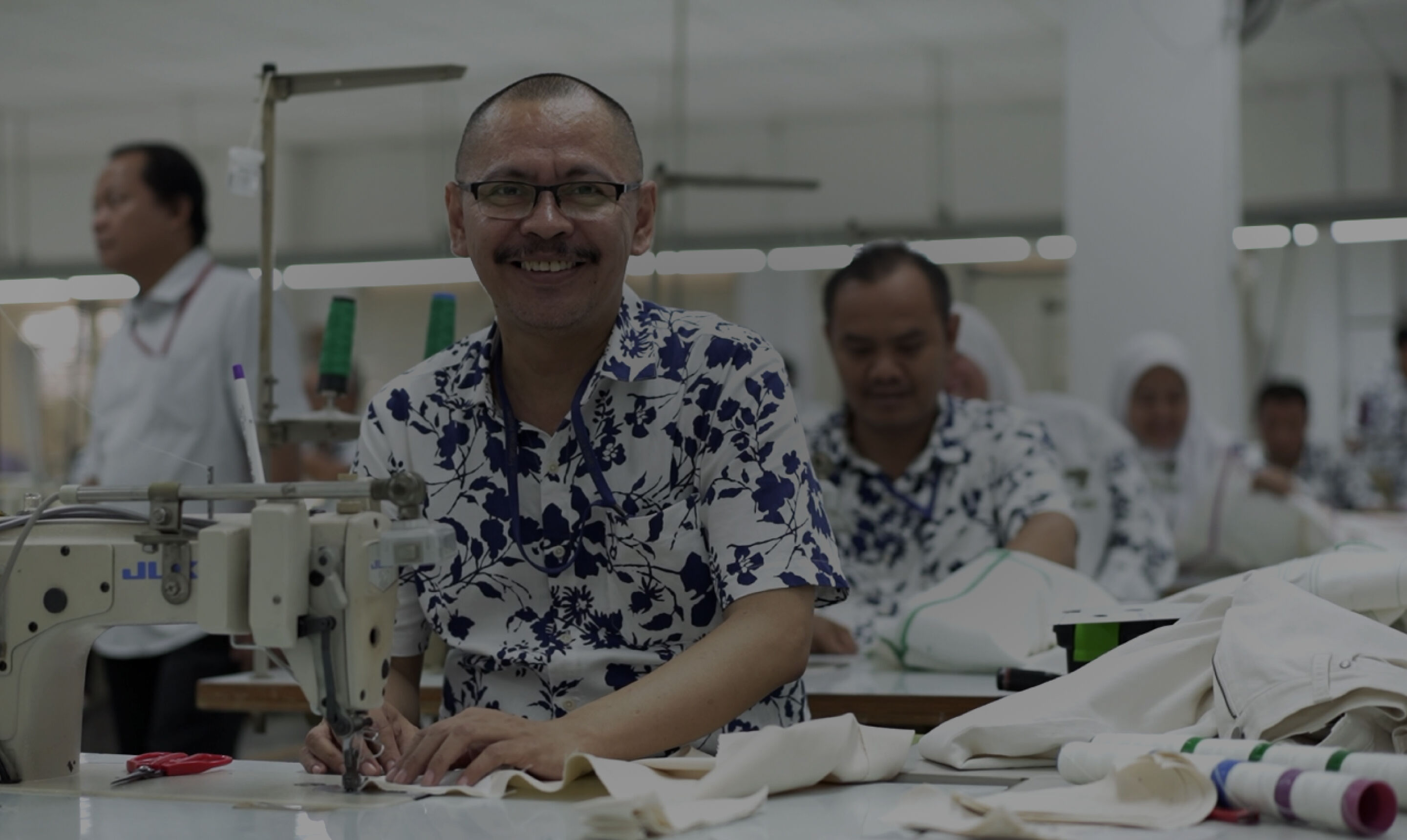 Man sewing in garment factory.