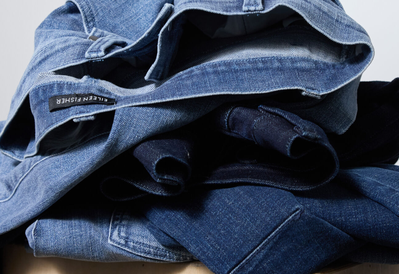 A stack of women's jeans in different washes.