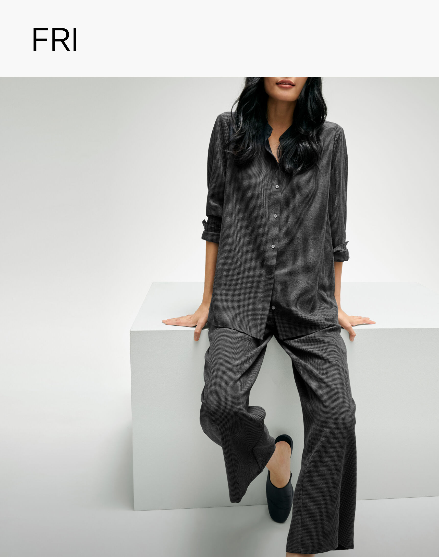 Woman wearing matching grey comfortable set from EILEEN FISHER.