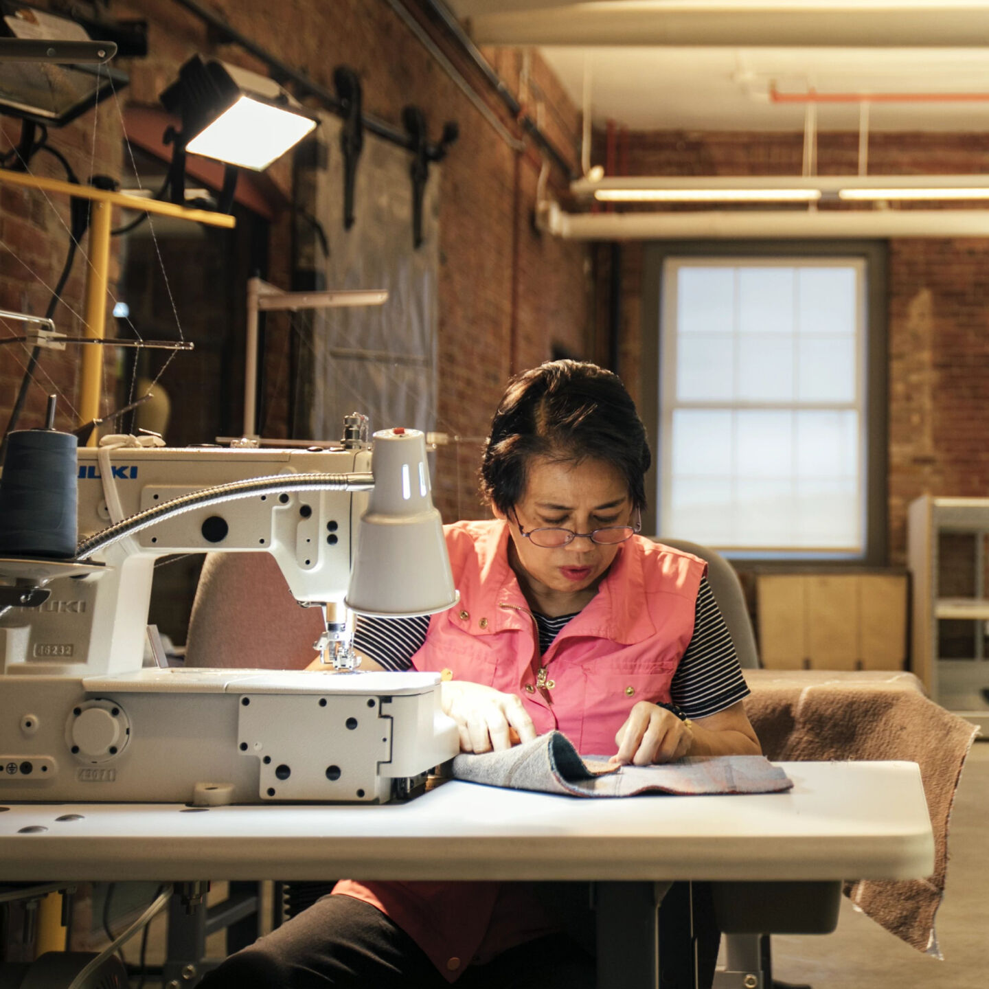 EILEEN FISHER employee sewing felted textile.