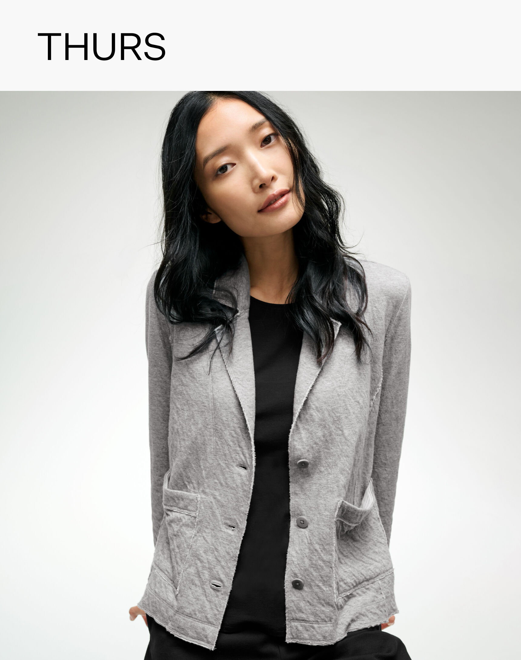 Woman wearing a soft blazer for work by EILEEN FISHER.