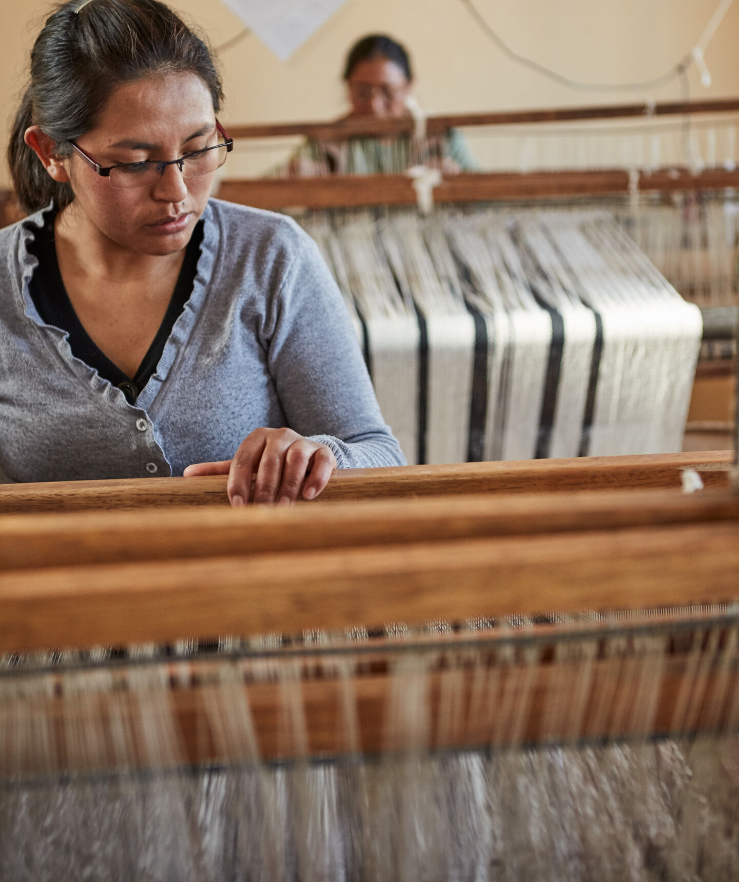 Peruvian woman working on loom.