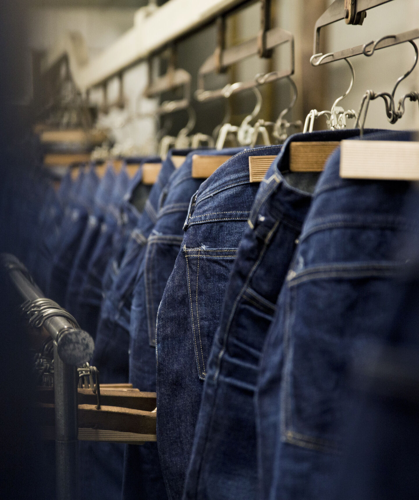 Jeans hanging at a denim factory. Jeans hanging at a denim factory.