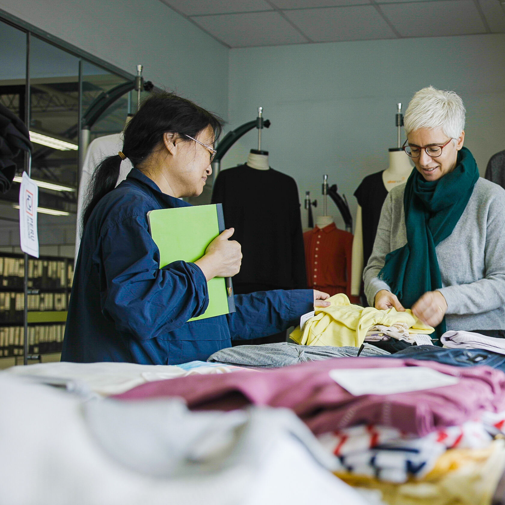 Examining fabric samples at our garment factory in Peru.