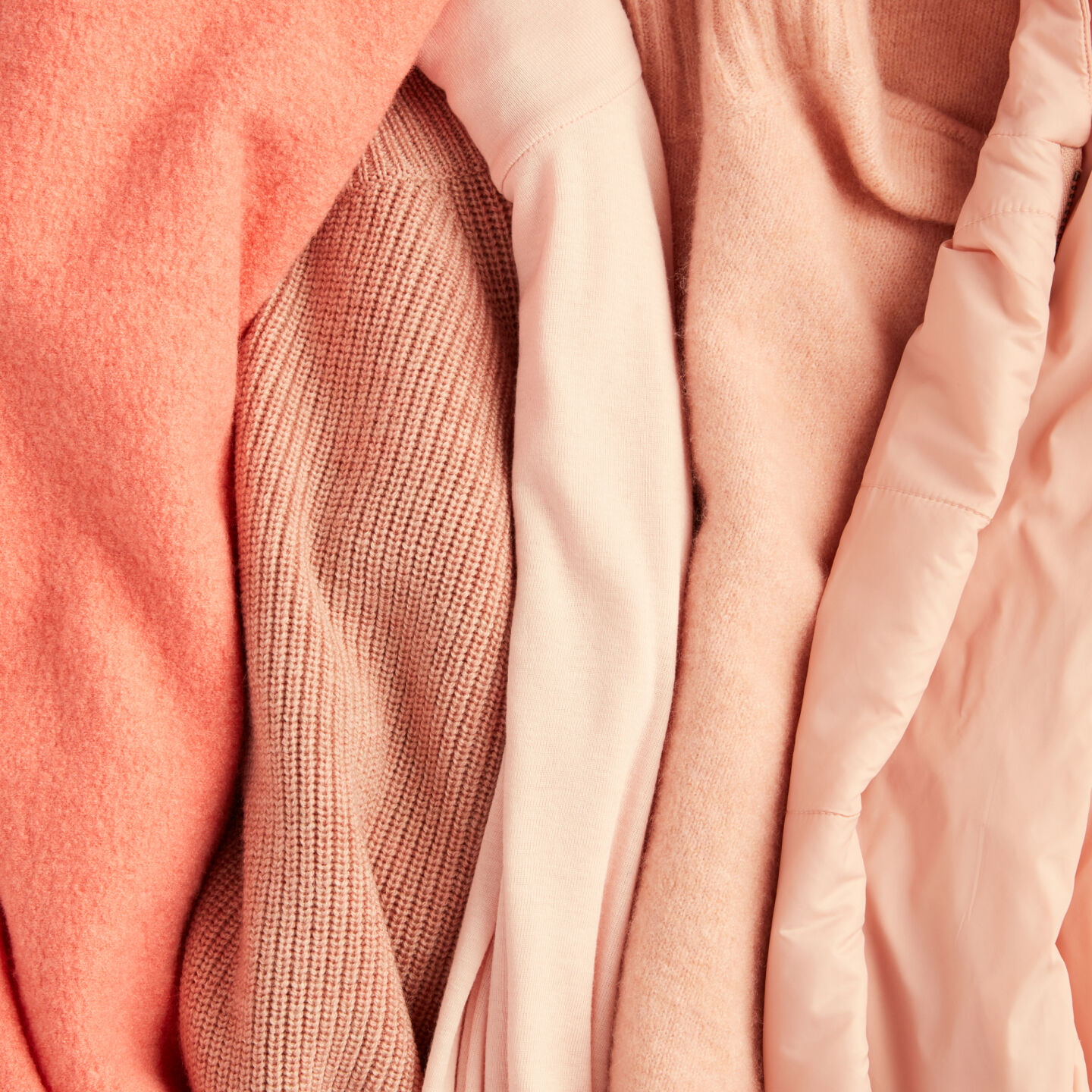 Peach colored sweaters and knits.