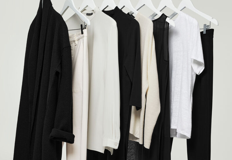 A rack of simple, timeless EILEEN FISHER clothes on a clothing rack.