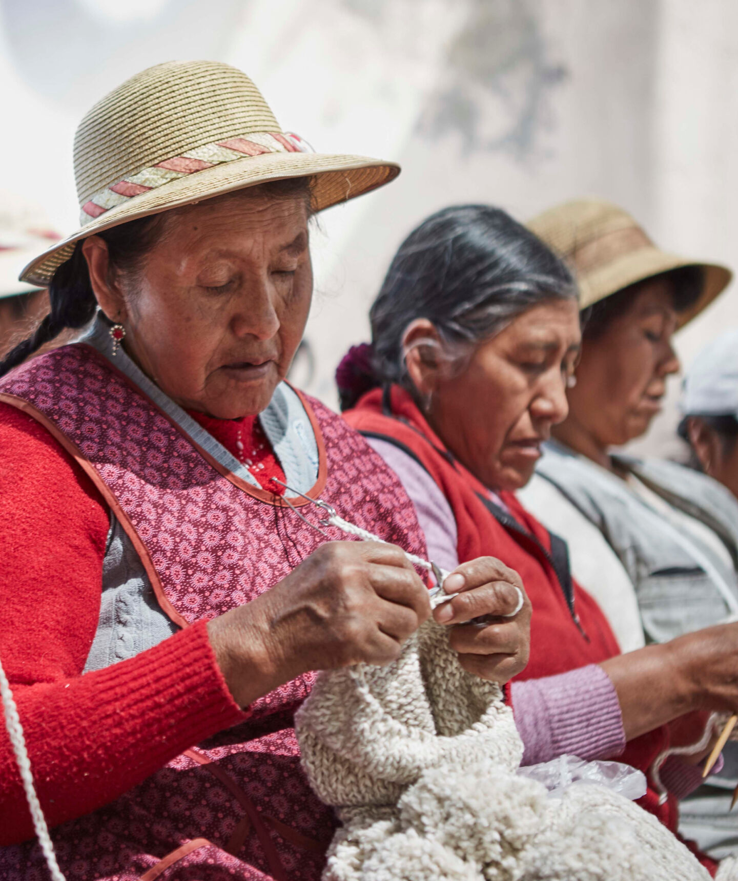 Peruvian women knitting sweaters.