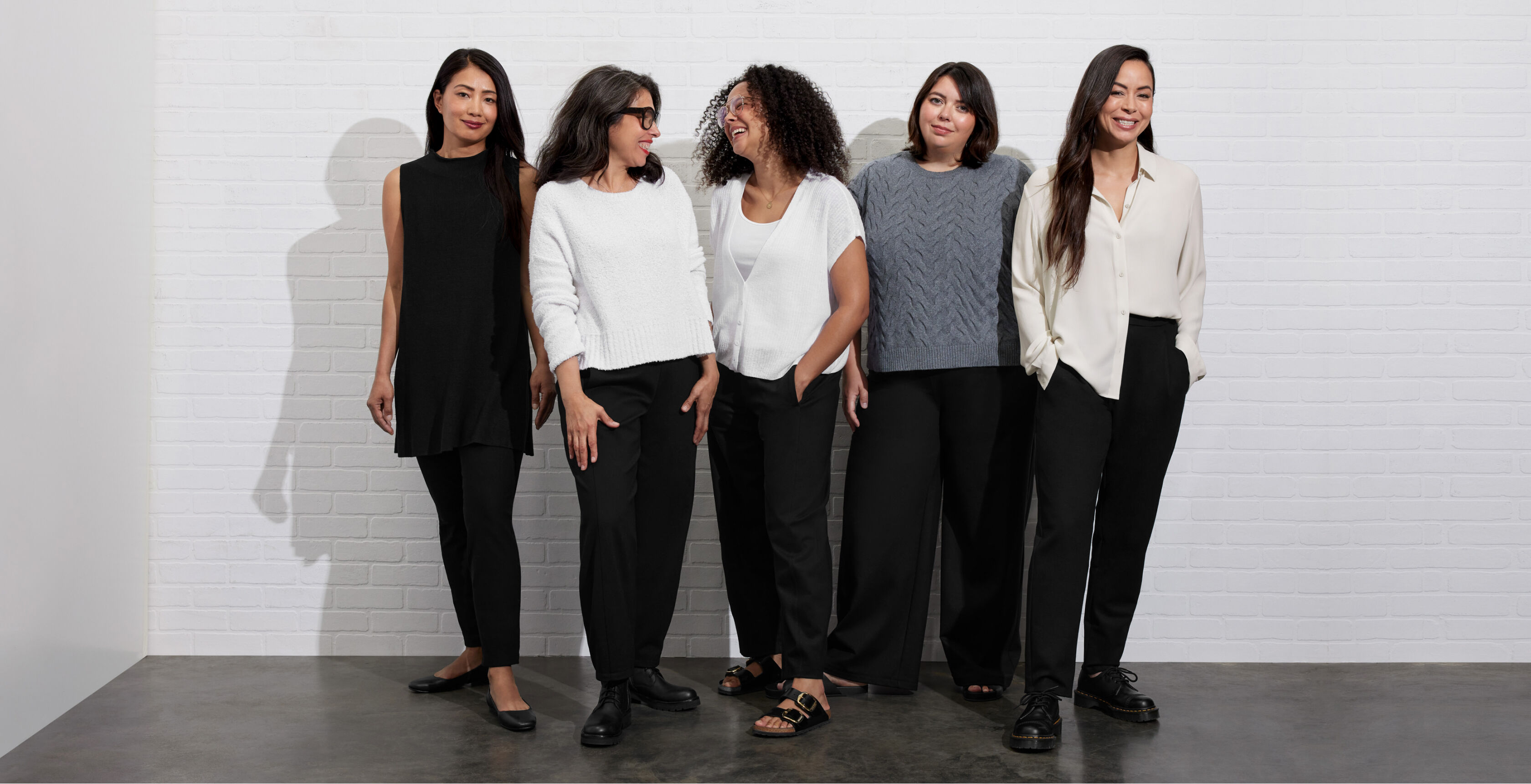 A group of women wearing different EILEEN FISHER pant shapes.