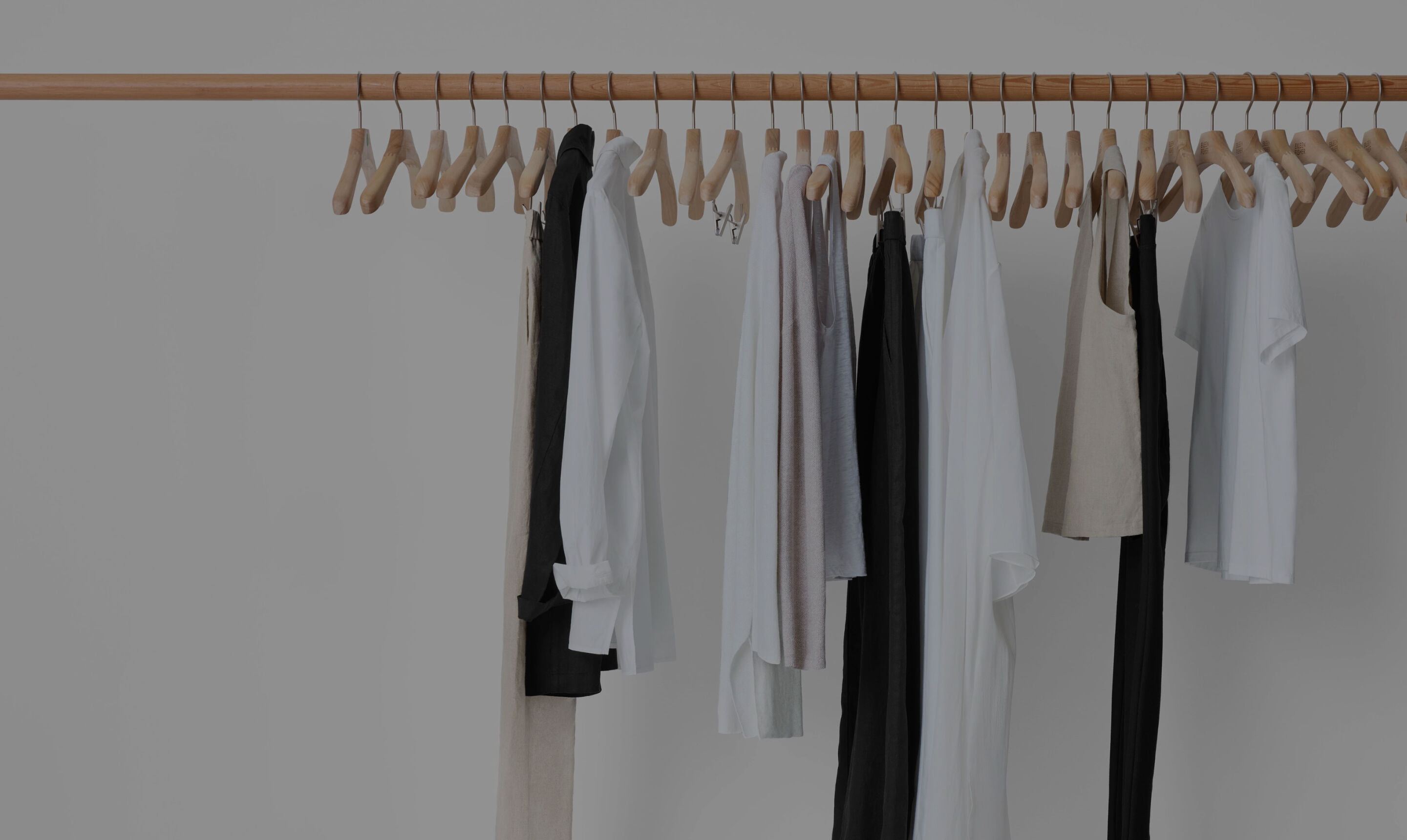 A clothing rack featuring a minimal wardrobe.