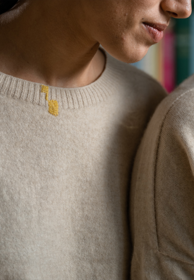 Women wearing sweaters with visible mending.