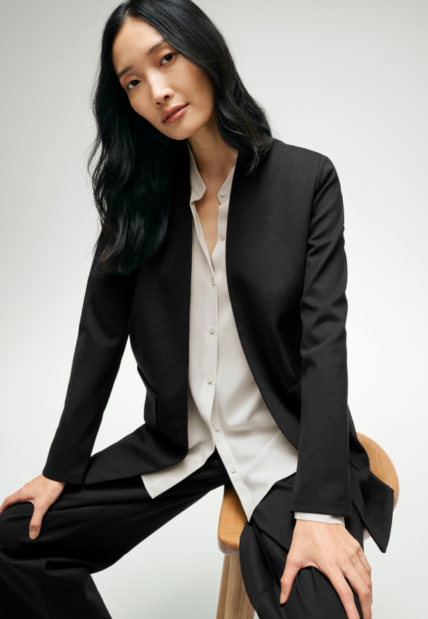 Woman wearing a comfortable black suit from EILEEN FISHER.