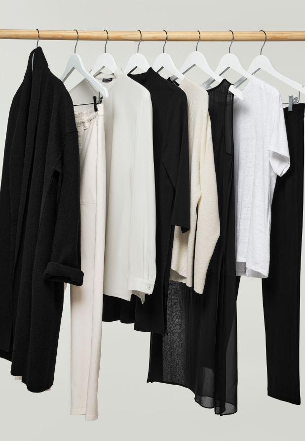 A rack of simple, timeless EILEEN FISHER clothes on a clothing rack.