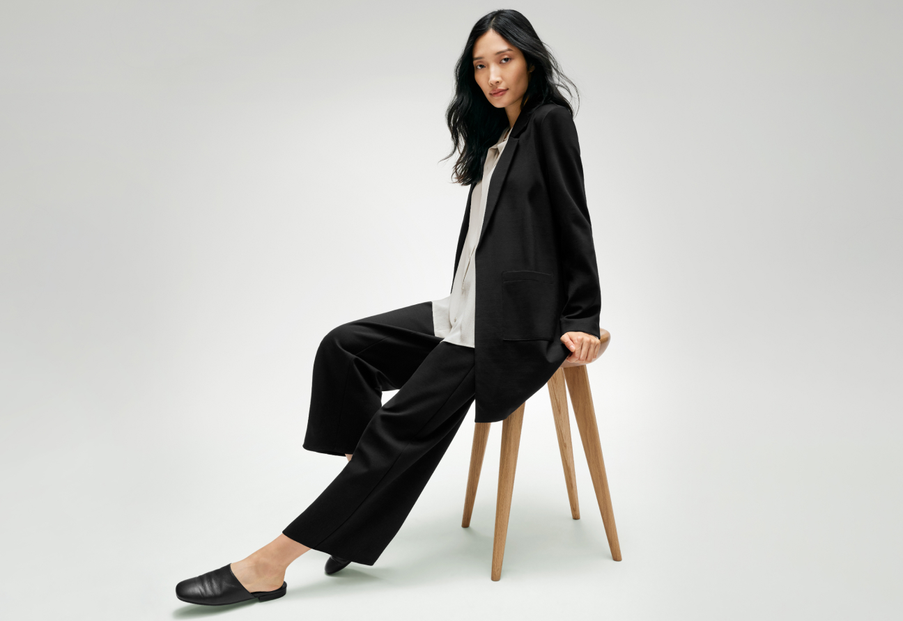 Woman wearing a comfortable black suit from EILEEN FISHER.