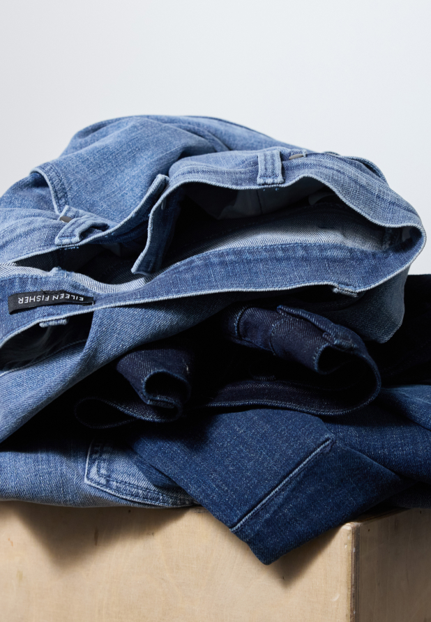 A stack of women's jeans in different washes.